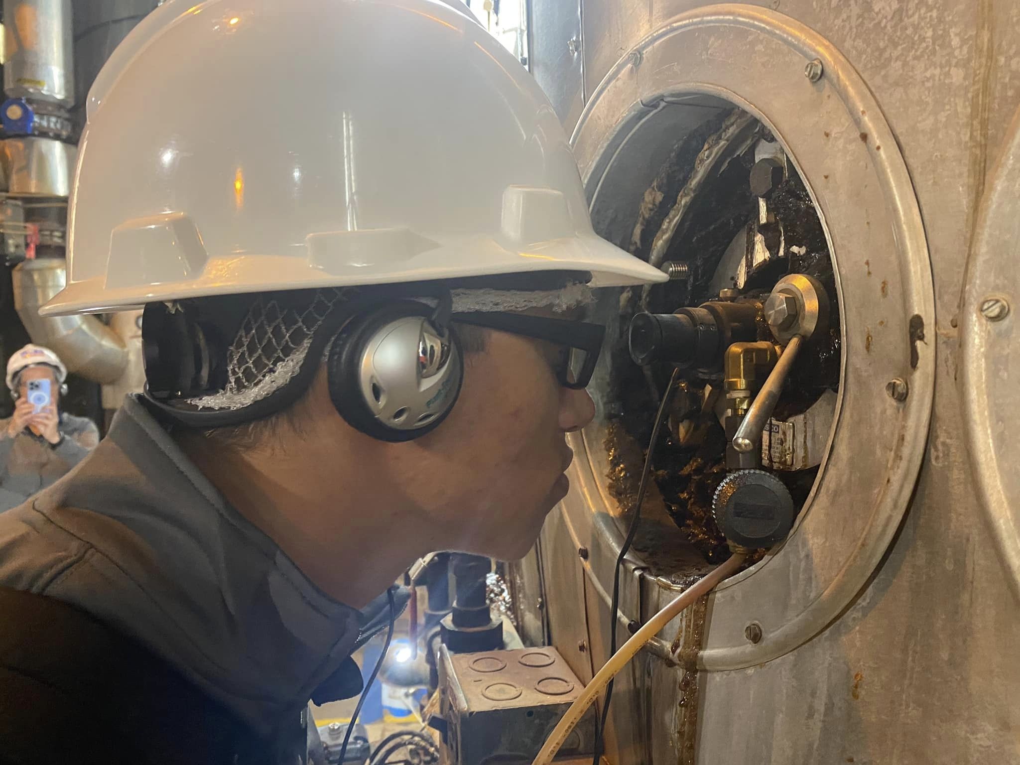 Student looking into sugar processing machine